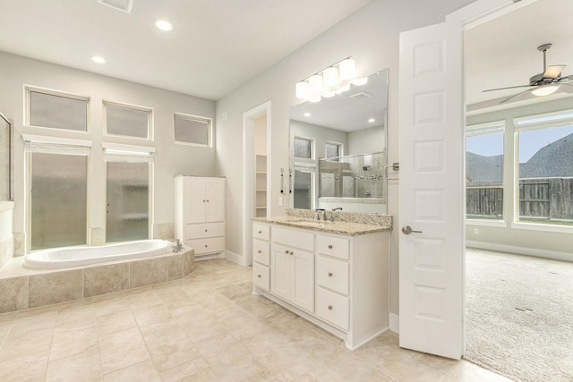 28622 Mountain Timber Ct, Fulshear, TX 77441 - bathroom featuring tiled tub, an enclosed shower, vanity, a ceiling fan, and recessed lighting