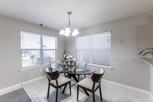 13507 Beech Ridge Ln, Houston, TX 77083 - dining area featuring a chandelier and baseboards