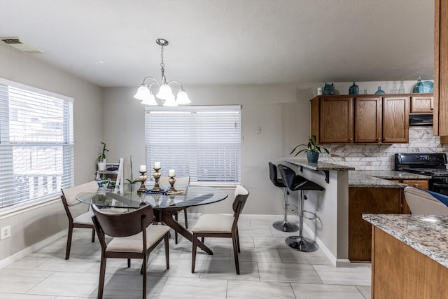 13507 Beech Ridge Ln, Houston, TX 77083 - dining area featuring baseboards and a chandelier