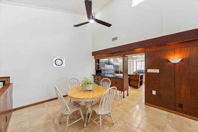 2414 Baycrest Dr, Houston, TX 77058 - dining area with a ceiling fan, a high ceiling, ornamental molding, light tile patterned floors, and baseboards