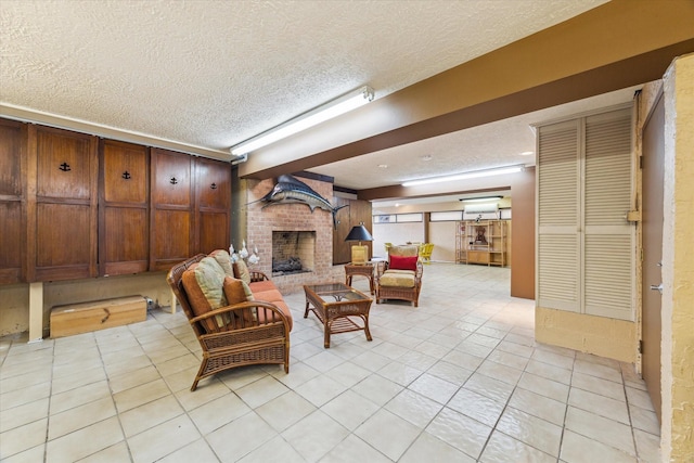 2414 Baycrest Dr, Houston, TX 77058 - living area with a textured ceiling, a brick fireplace, and light tile patterned flooring