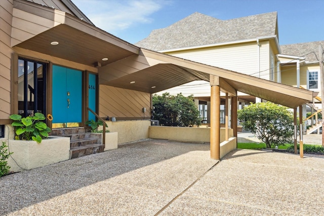 2414 Baycrest Dr, Houston, TX 77058 - view of patio featuring entry steps, concrete driveway, and an attached carport