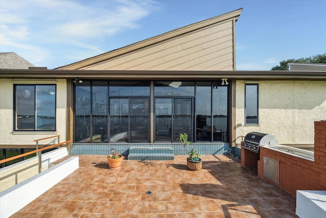 2414 Baycrest Dr, Houston, TX 77058 - back of property featuring a sunroom, an outdoor kitchen, and a patio