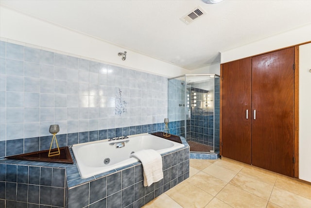 2414 Baycrest Dr, Houston, TX 77058 - bathroom with a stall shower, a jetted tub, and tile patterned flooring
