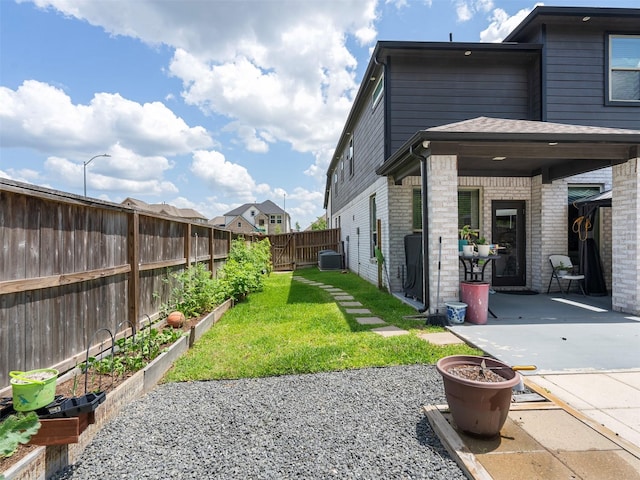 2815 Skerne Forest Dr, Spring, TX 77373 - view of yard with a vegetable garden, a patio, and central AC