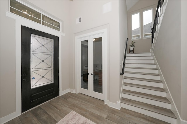 413 Stratus View Ct, Katy, TX 77493 - foyer featuring french doors, stairs, baseboards, and wood finished floors