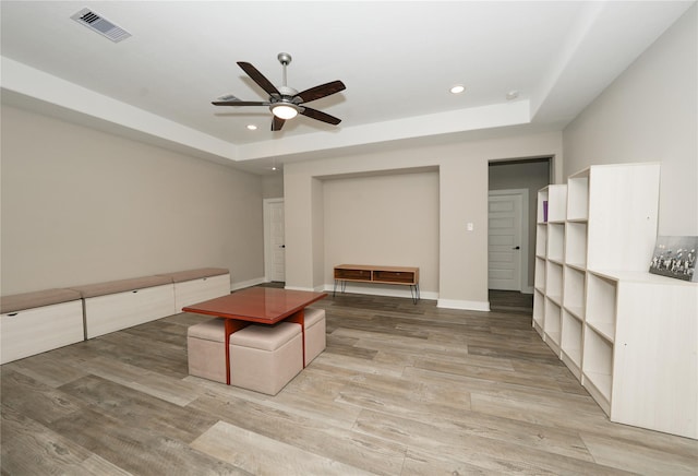 413 Stratus View Ct, Katy, TX 77493 - unfurnished living room featuring a tray ceiling, recessed lighting, ceiling fan, light wood finished floors, and baseboards