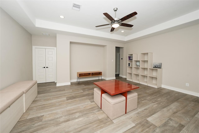 413 Stratus View Ct, Katy, TX 77493 - living room with a raised ceiling, ceiling fan, light wood-type flooring, baseboards, and recessed lighting