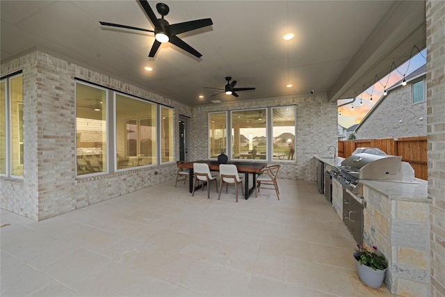 413 Stratus View Ct, Katy, TX 77493 - view of patio with area for grilling, fence, ceiling fan, outdoor dining area, and a sink