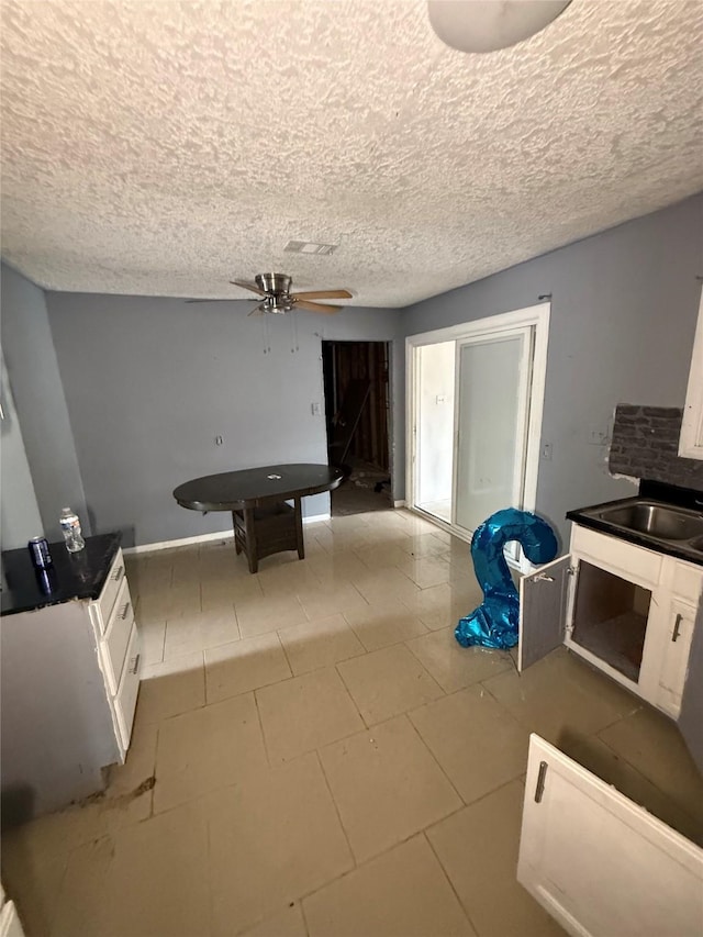 10211 Glenmawr Dr, Houston, TX 77075 - game room with ceiling fan, a sink, a textured ceiling, and baseboards