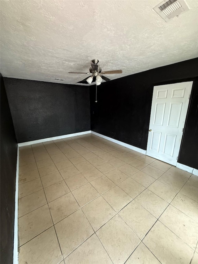 10211 Glenmawr Dr, Houston, TX 77075 - spare room with ceiling fan, light tile patterned floors, a textured ceiling, and baseboards