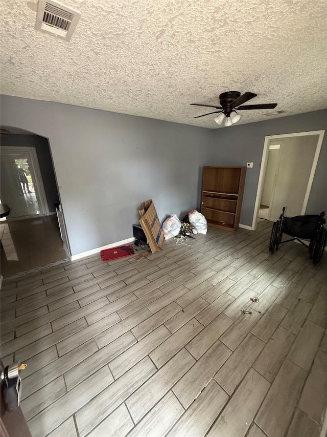 10211 Glenmawr Dr, Houston, TX 77075 - unfurnished bedroom featuring wood finished floors, a textured ceiling, baseboards, and a ceiling fan