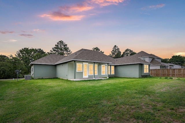 26579 Pin Oak Dr, Hempstead, TX 77445 - back of property at dusk featuring central AC unit and a shingled roof