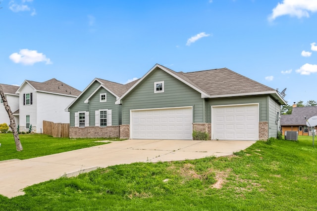 26579 Pin Oak Dr, Hempstead, TX 77445 - traditional-style home featuring brick siding, driveway, a garage, central air condition unit, and a shingled roof
