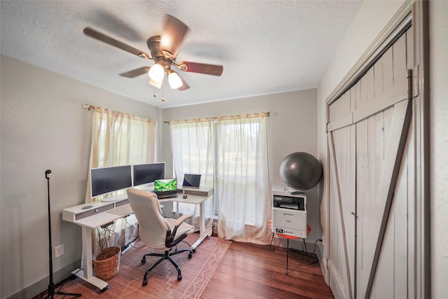 7477 Hidden Acres Dr, Cleveland, TX 77328 - home office with wood finished floors, ceiling fan, and a textured ceiling