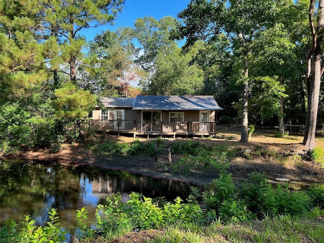 7477 Hidden Acres Dr, Cleveland, TX 77328 - back of house featuring a deck with water view