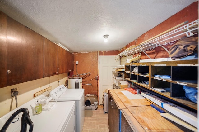 7477 Hidden Acres Dr, Cleveland, TX 77328 - washroom featuring electric water heater, separate washer and dryer, cabinet space, and a textured ceiling