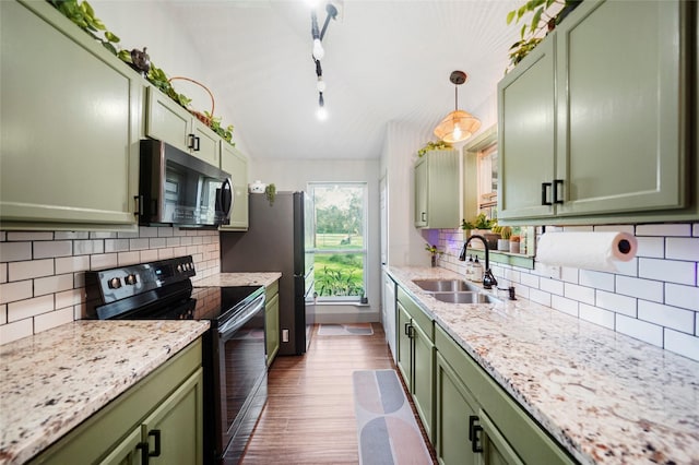 7477 Hidden Acres Dr, Cleveland, TX 77328 - kitchen featuring green cabinets, appliances with stainless steel finishes, dark wood-style floors, backsplash, and vaulted ceiling