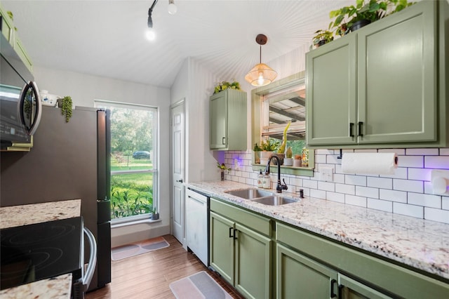 7477 Hidden Acres Dr, Cleveland, TX 77328 - kitchen featuring green cabinets, appliances with stainless steel finishes, tasteful backsplash, dark wood-type flooring, and lofted ceiling