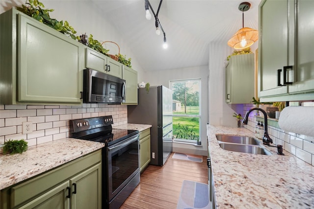 7477 Hidden Acres Dr, Cleveland, TX 77328 - kitchen featuring green cabinets, stainless steel appliances, lofted ceiling, and backsplash