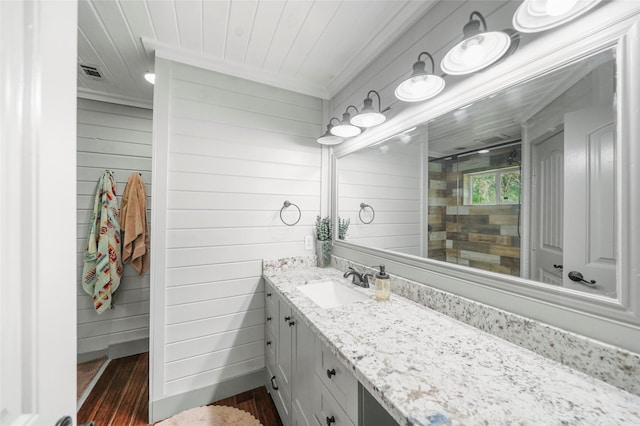 7477 Hidden Acres Dr, Cleveland, TX 77328 - full bath with wood finished floors, wood walls, vanity, wood ceiling, and a tile shower