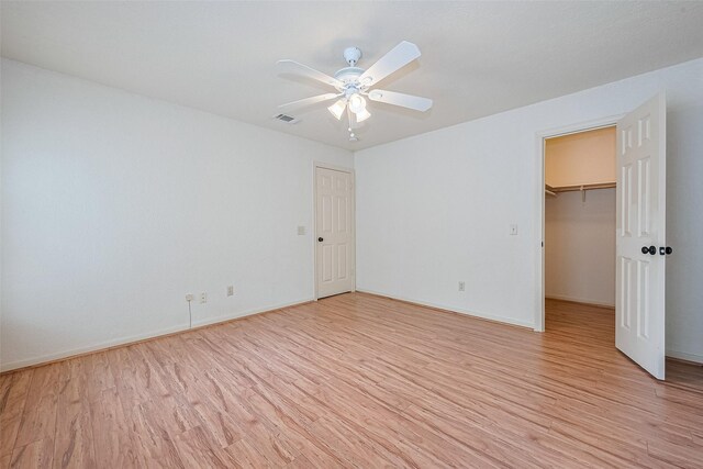 3614 Bee Bayou Ln, Sugar Land, TX 77479 - unfurnished bedroom featuring light wood finished floors, a spacious closet, a closet, and baseboards