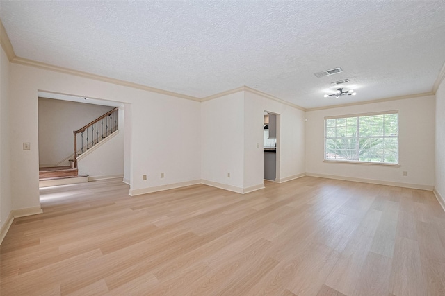 3614 Bee Bayou Ln, Sugar Land, TX 77479 - spare room featuring light wood finished floors, a textured ceiling, stairway, ornamental molding, and baseboards