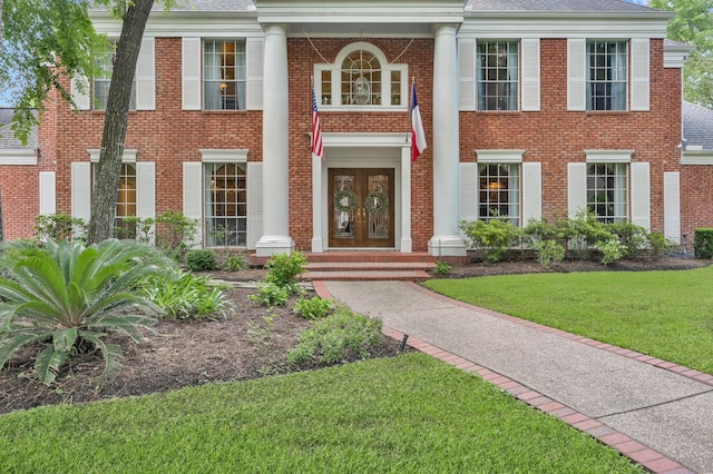 11774 Quail Creek Dr, Houston, TX 77070 - greek revival inspired property featuring french doors, brick siding, a front lawn, and a shingled roof