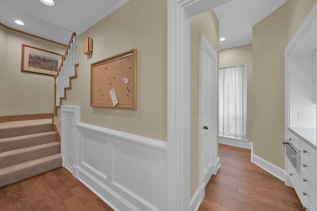 11774 Quail Creek Dr, Houston, TX 77070 - corridor featuring wood finished floors, crown molding, stairs, wainscoting, and recessed lighting