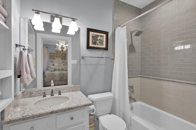 11774 Quail Creek Dr, Houston, TX 77070 - bathroom featuring a chandelier, shower / bath combo with shower curtain, connected bathroom, vanity, and toilet