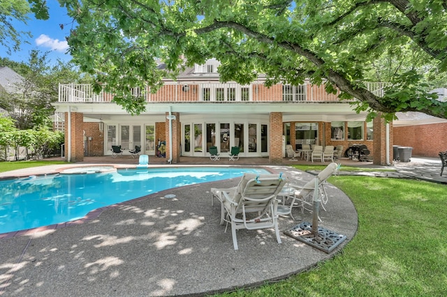 11774 Quail Creek Dr, Houston, TX 77070 - back of property featuring a patio, brick siding, an outdoor living space, and an outdoor pool