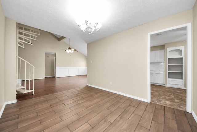 1115 Vang Ct, Crosby, TX 77532 - unfurnished living room featuring wood finished floors, ceiling fan, stairs, a chandelier, and a textured ceiling