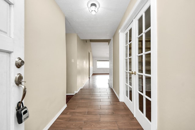 1115 Vang Ct, Crosby, TX 77532 - corridor with french doors, wood finished floors, a textured ceiling, and baseboards