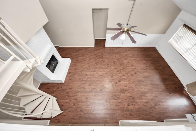 1115 Vang Ct, Crosby, TX 77532 - unfurnished living room featuring ceiling fan, a fireplace with raised hearth, wood finished floors, and baseboards