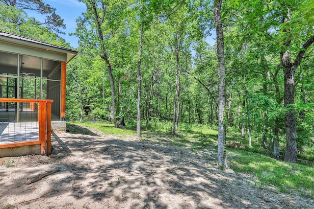 777 S Cape Royale Dr, Coldspring, TX 77331 - view of yard with a sunroom and a forest view
