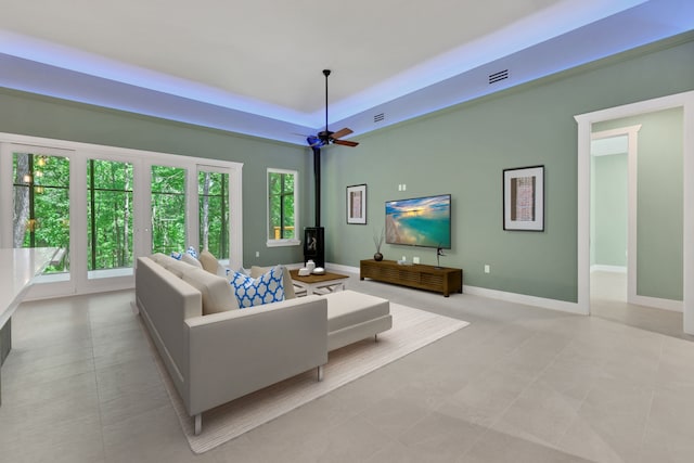 777 S Cape Royale Dr, Coldspring, TX 77331 - living area with healthy amount of natural light, a tray ceiling, ceiling fan, and baseboards