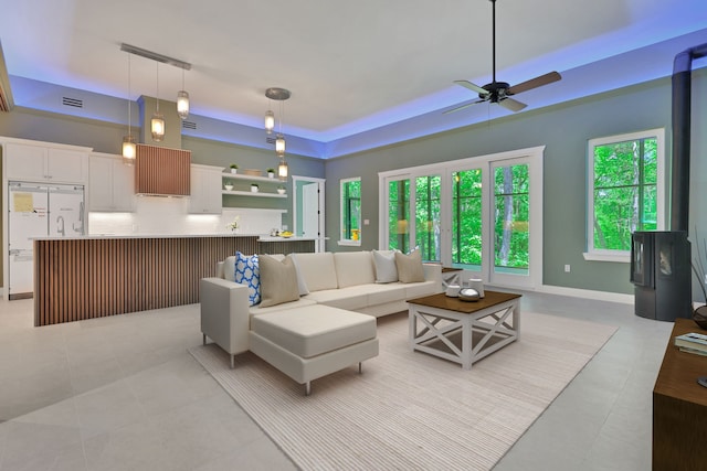 777 S Cape Royale Dr, Coldspring, TX 77331 - living room featuring ceiling fan, light tile patterned floors, and a raised ceiling