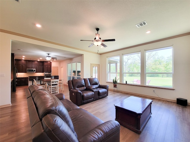 2755 Overlook Rd, Caldwell, TX 77836 - living area featuring a ceiling fan, wood finished floors, recessed lighting, baseboards, and ornamental molding