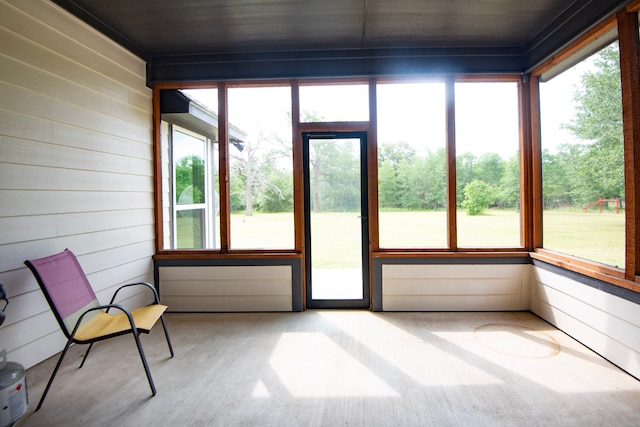 2755 Overlook Rd, Caldwell, TX 77836 - unfurnished sunroom featuring plenty of natural light, wood finished floors, wood walls, and wood ceiling