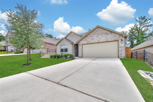 922 Golden Willow Ln, Conroe, TX 77304 - view of front of property with driveway, a garage, and brick siding