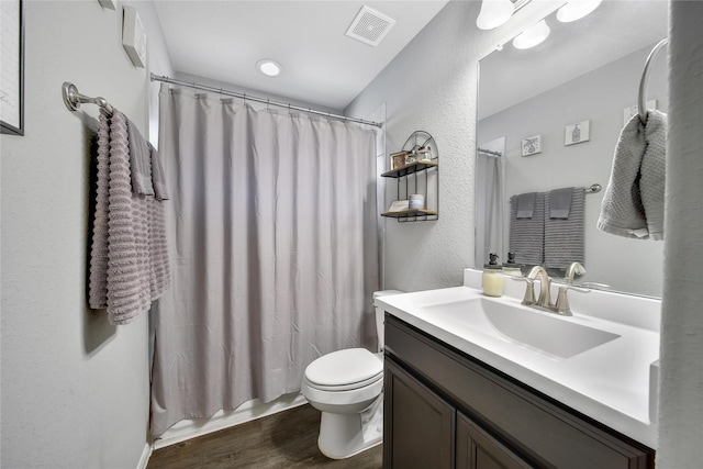 922 Golden Willow Ln, Conroe, TX 77304 - full bath featuring wood finished floors, toilet, vanity, and a textured wall