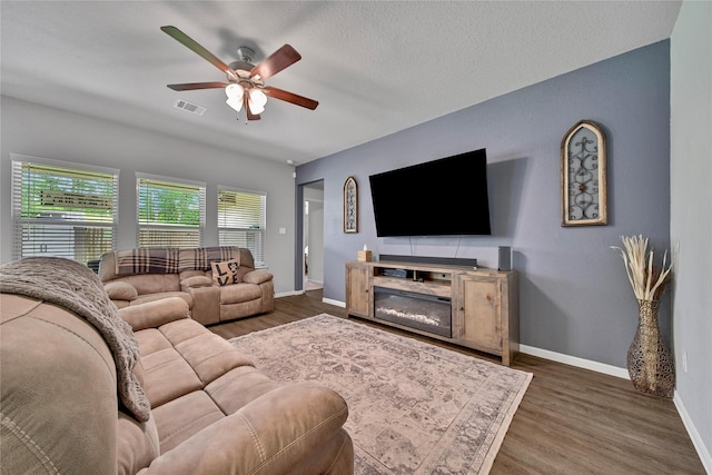 922 Golden Willow Ln, Conroe, TX 77304 - living area featuring a ceiling fan, baseboards, and wood finished floors