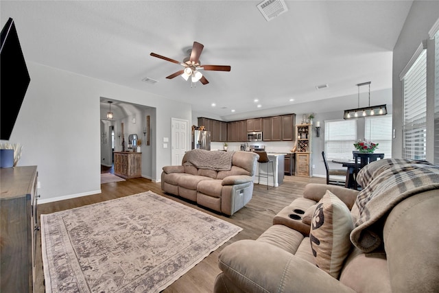 922 Golden Willow Ln, Conroe, TX 77304 - living area featuring a ceiling fan, light wood-style floors, baseboards, recessed lighting, and a chandelier