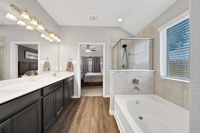 922 Golden Willow Ln, Conroe, TX 77304 - ensuite bathroom featuring plenty of natural light, a ceiling fan, a bath, wood finished floors, and vaulted ceiling