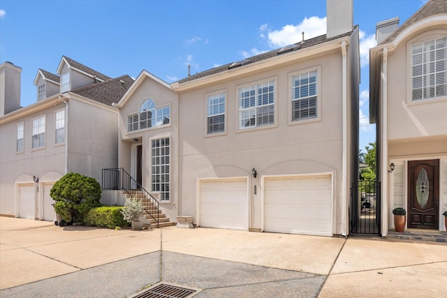3007 Sackett St, Houston, TX 77098 - townhome / multi-family property with concrete driveway, a garage, stucco siding, and a chimney