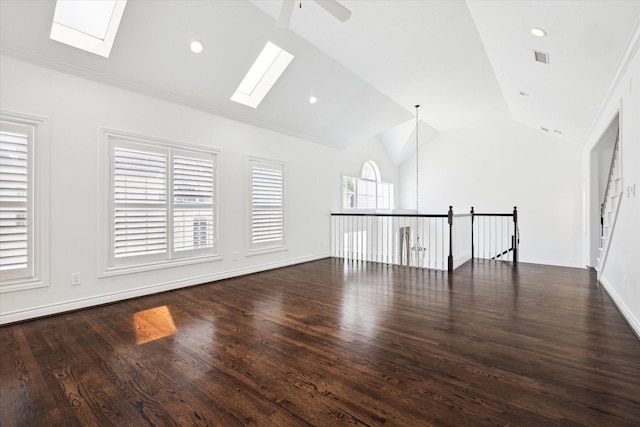 3007 Sackett St, Houston, TX 77098 - spare room featuring a skylight, lofted ceiling, wood finished floors, baseboards, and a ceiling fan