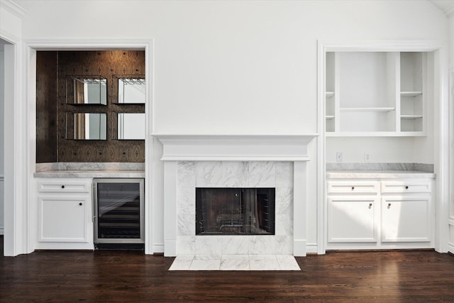 3007 Sackett St, Houston, TX 77098 - unfurnished living room with beverage cooler, dark wood-style flooring, a high end fireplace, and built in features