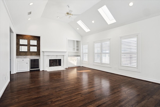 3007 Sackett St, Houston, TX 77098 - unfurnished living room with beverage cooler, a skylight, lofted ceiling, built in features, and dark wood-style floors
