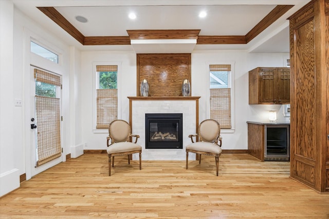 1010 Cortlandt St, Houston, TX 77008 - living area featuring wine cooler, light wood-style floors, a tile fireplace, a tray ceiling, and baseboards