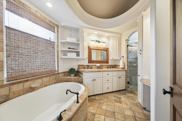 1010 Cortlandt St, Houston, TX 77008 - bathroom featuring stone tile floors, a bath, a stall shower, recessed lighting, and double vanity